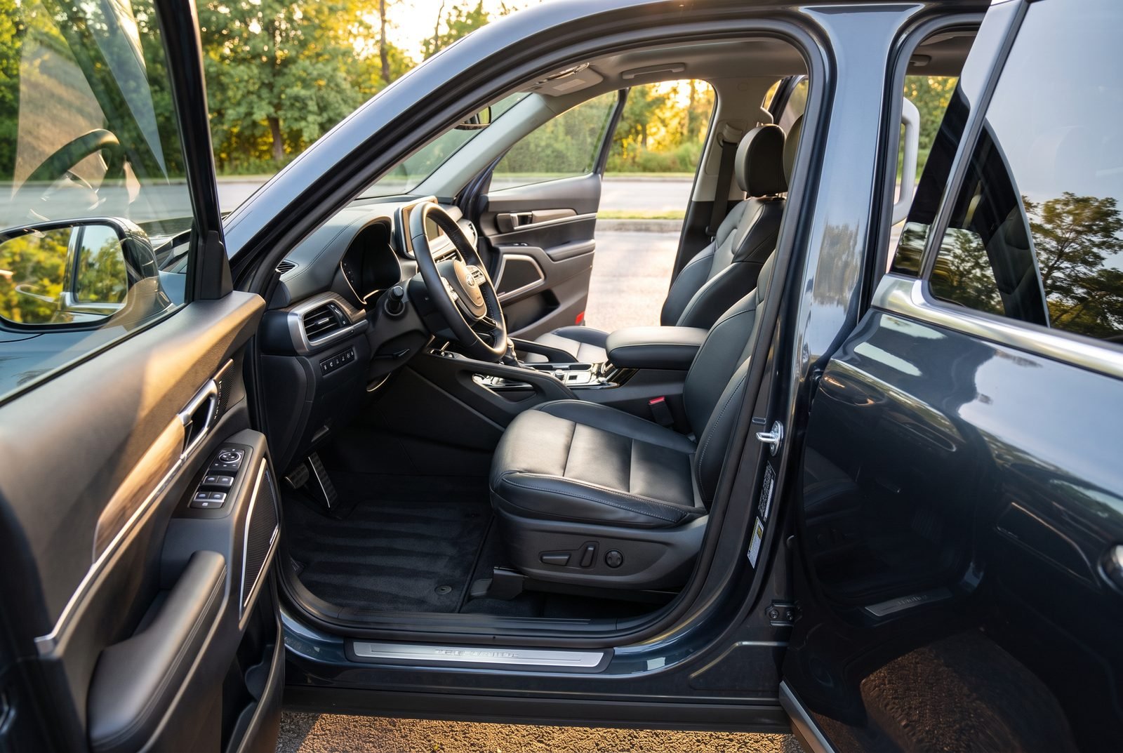 The cleaned interior of a Kia Telluride with seats, console and carpets immaculate.